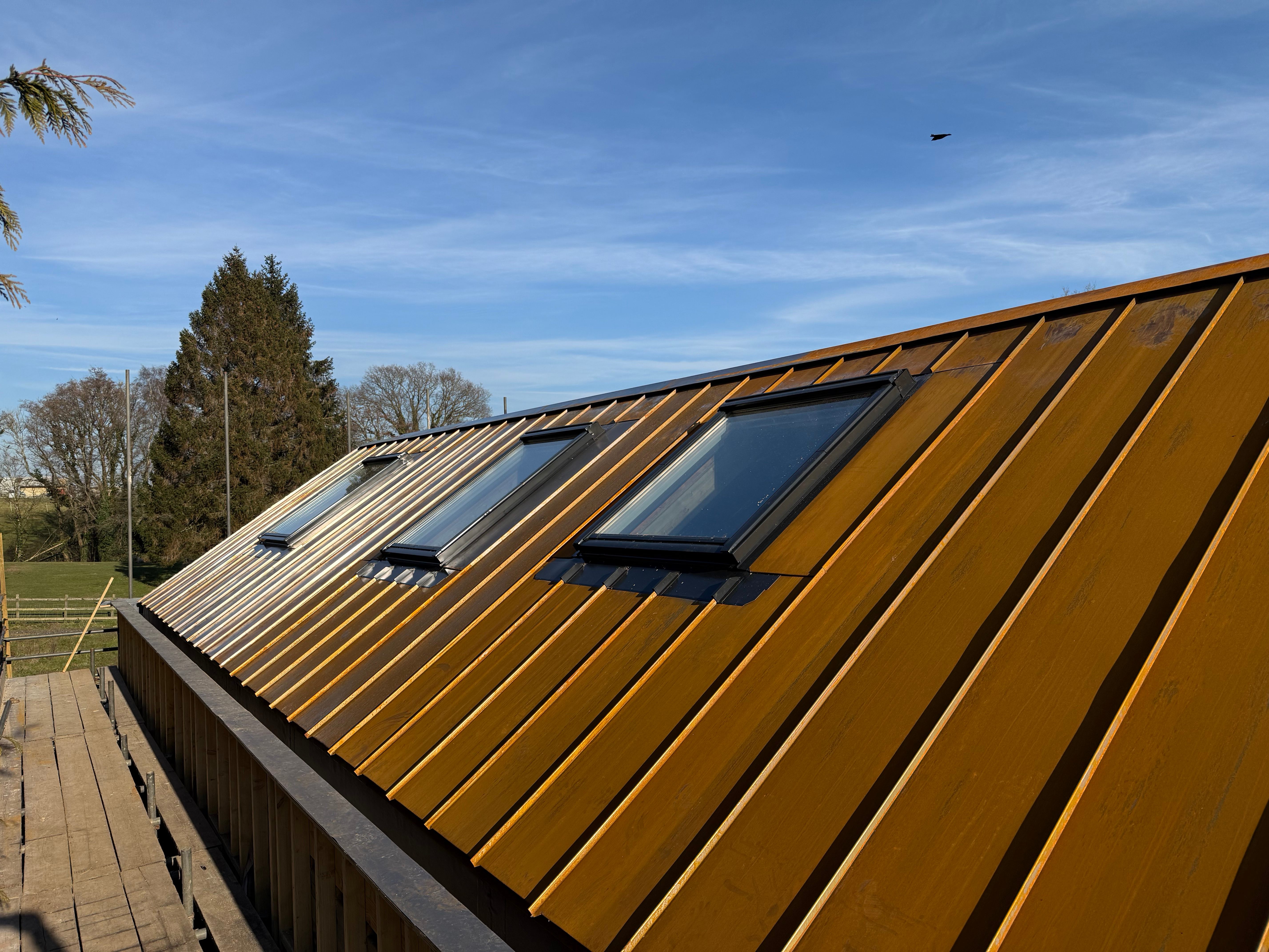 Corten steel standing seam roofing with skylights